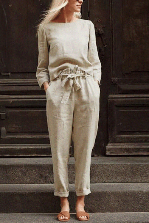 Woman wearing cotton-linen monochrome relaxed longline top and wide-leg pants set in neutral beige color