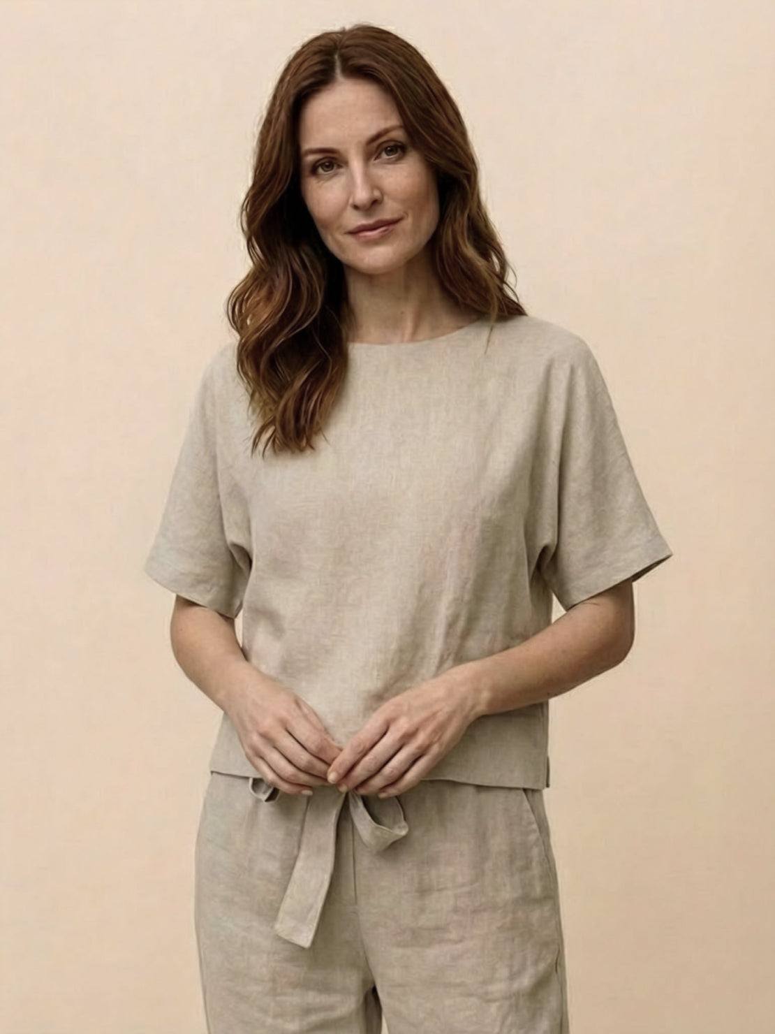 Woman wearing relaxed cotton linen set with short-sleeve top and straight-leg pants in monochrome tone