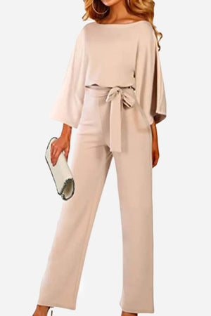Beige casual long sleeve belted jumpsuit with wide sleeves and a round neck, styled with a belt at the natural waist.