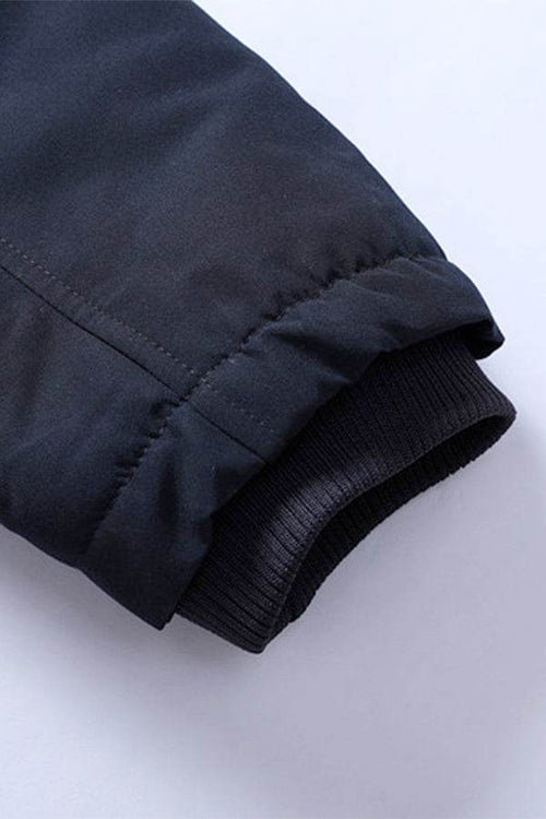 Close-up of sleeve cuff on thick long-sleeve zipper overcoat showing durable fabric and elastic ribbing detail