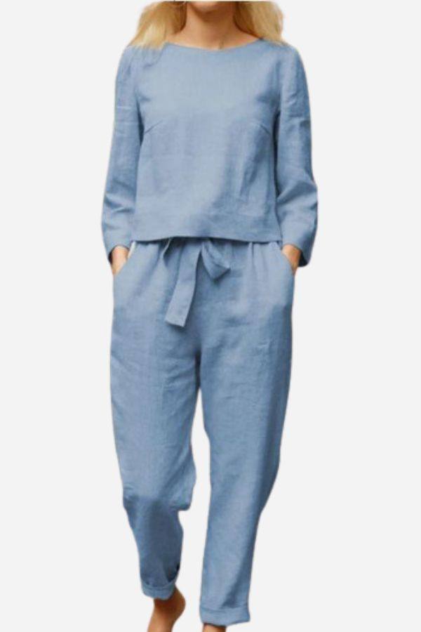 Woman wearing light blue 100% cotton linen monochrome two-piece set with long sleeves and pants with waist tie