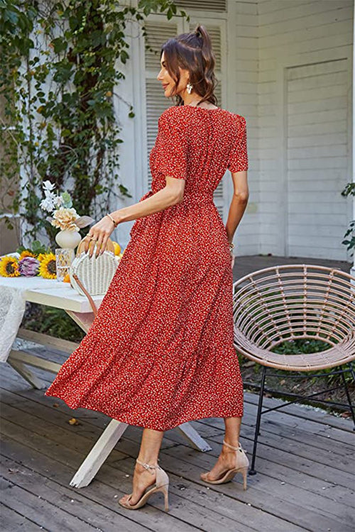 Woman wearing a red Charming Floral Boho Maxi Dress with short sleeves and flowing skirt outdoors on patio