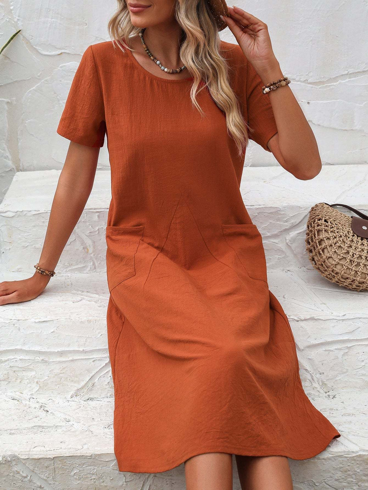 Radiant Escape Panelled Beach Dress in rust color with short sleeves and round neckline, midi-length A-line style, made of soft polyester fabric.