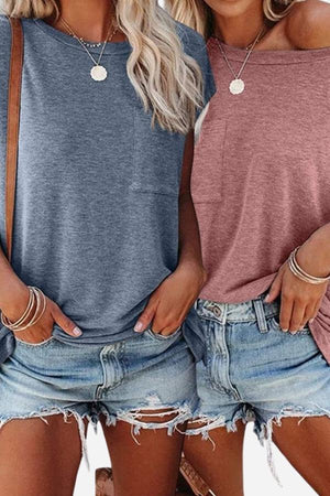 Two women wearing Easy Breezy Tunic Shirts in blue and pink with front pockets and casual denim shorts