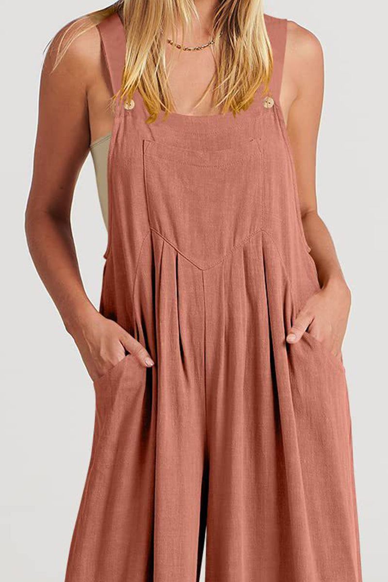 Woman wearing soft breathable cotton Free-Flow Wide Leg Overalls in dusty rose with pockets and adjustable straps