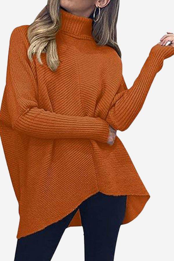 Cozy oversized knitted pullover in burnt orange with a high neck and relaxed fit.