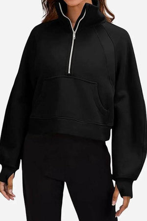 black cozy oversized half-zip fleece pullover sweatshirt with front pocket and long sleeves