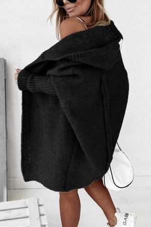 woman wearing black warm oversized hooded cardigan with relaxed fit and hood outside