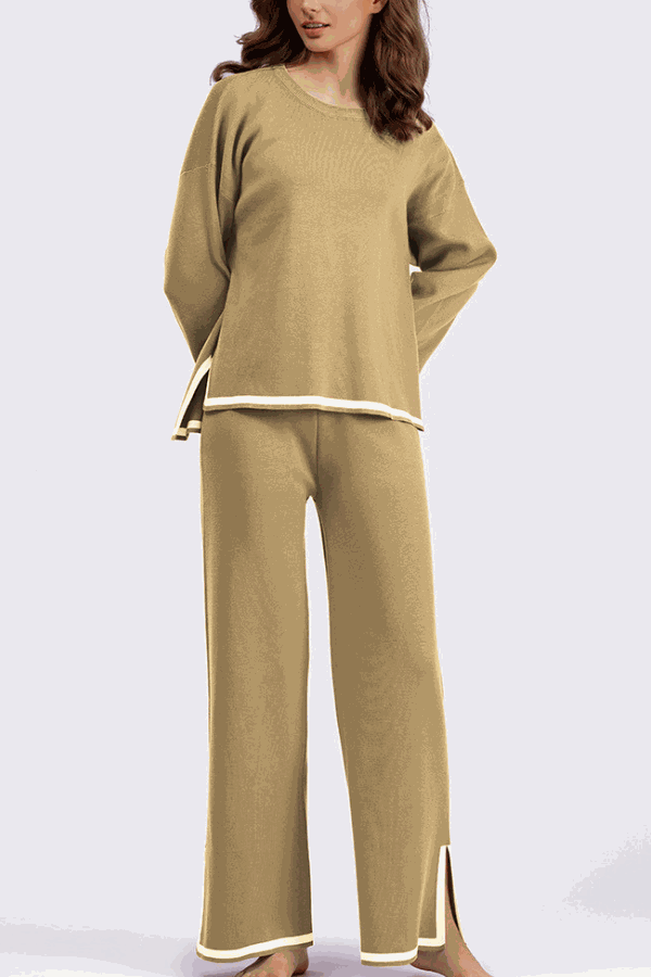 Woman wearing a beige long sleeved relaxed fit lounge two-piece set with wide-leg pants and side slits