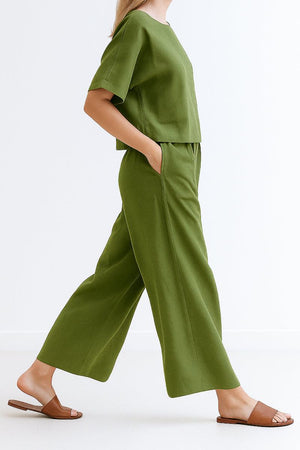 Olive green loose fit co-ord set with relaxed short-sleeve top and wide-leg pants, styled with brown sandals.