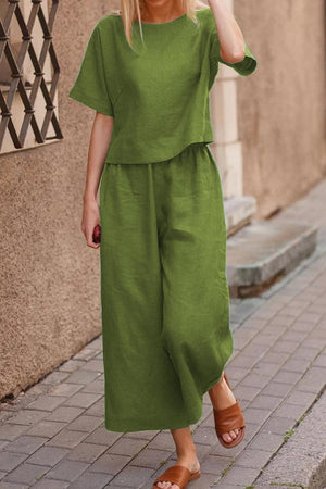 Woman wearing relaxed green loose fit co-ord set with wide-leg pants walking outdoors