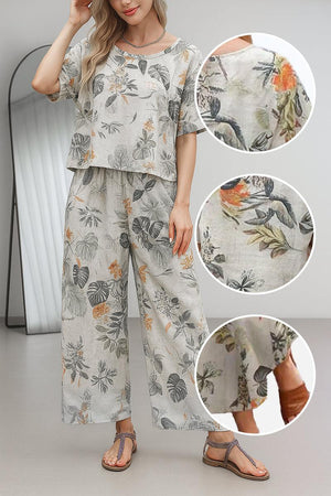 Woman wearing floral print loose fit co-ord set with wide-leg pants and short-sleeve top in light breathable fabric