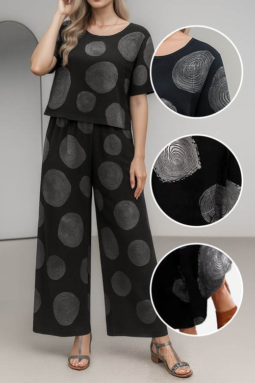 Black loose fit co-ord set with wide-leg pants and short-sleeve top featuring circular patterns