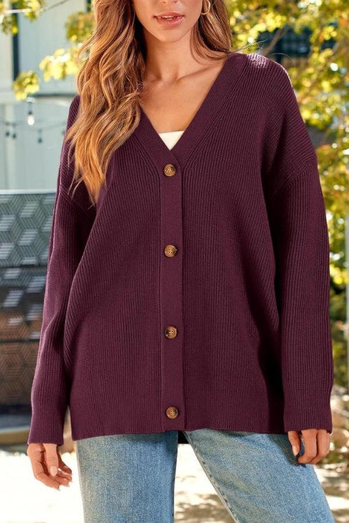 Relaxed fit oversized button down knitwear cardigan in dark purple worn with jeans outdoors