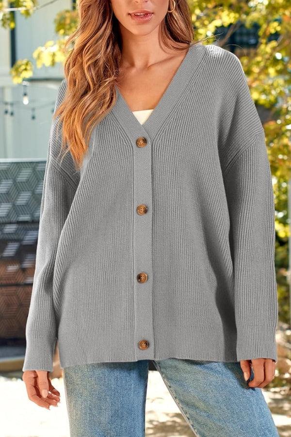 Woman wearing relaxed fit oversized gray knit cardigan with buttons outdoors