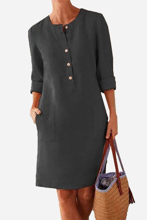 Classic black cotton dress with half-button front and rolled 3/4 sleeves for casual elegance