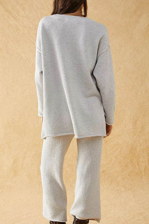 Woman wearing light grey textured two-piece oversized set for multi-weather comfort, featuring long sleeves and wide pants.