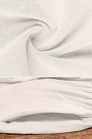 Close-up of soft, breathable fabric for capped-sleeve voluminous pleated midi dress in light beige color