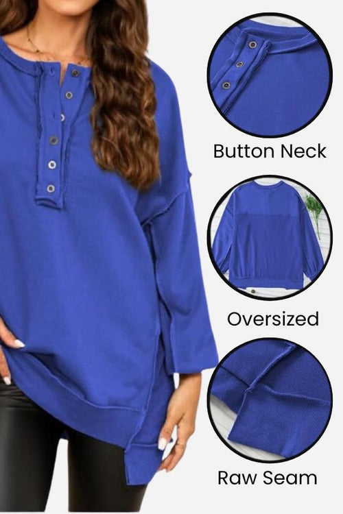 Blue oversized urban sweatshirt with button neck, raw seam details, and asymmetrical hem.