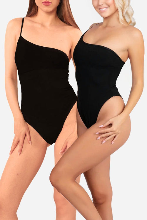 Two women wearing black asymmetric anti-tan line one-piece swimsuits with one-shoulder design against a white background