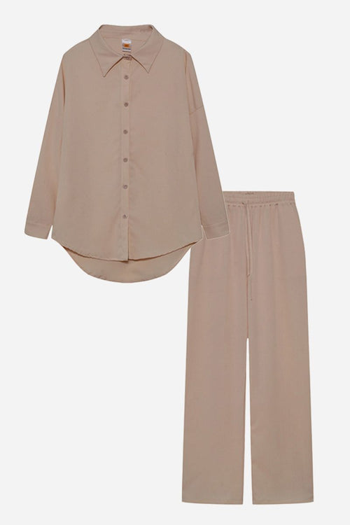 Beige professional two-piece set with button-up shirt and matching trousers for a smart, wrinkle-resistant look.