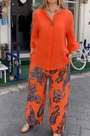 woman wearing vibrant fusion two-piece set with orange top and patterned wide-leg pants