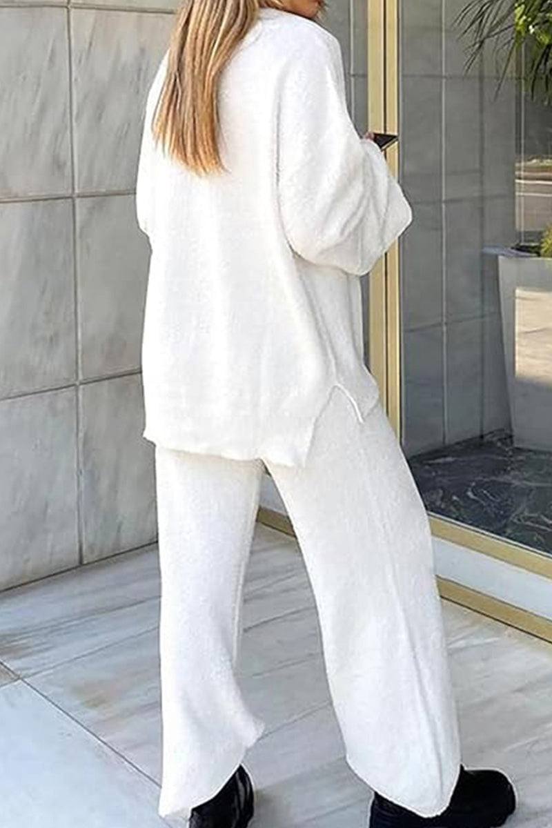 Woman wearing white Travel-Ease Two-Piece Set with loose fit and soft fabric, standing outdoors.