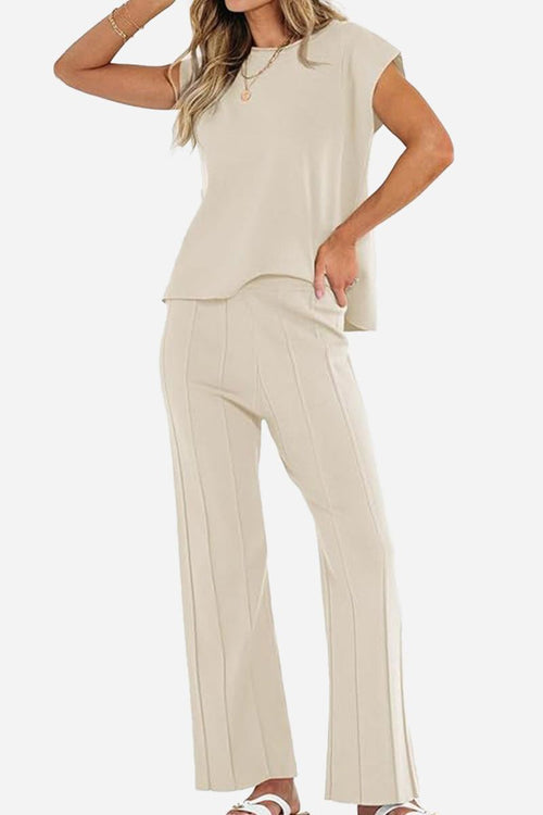 First Class Travel beige two-piece set with soft pleated pants and short sleeve top for stylish comfortable travel wear
