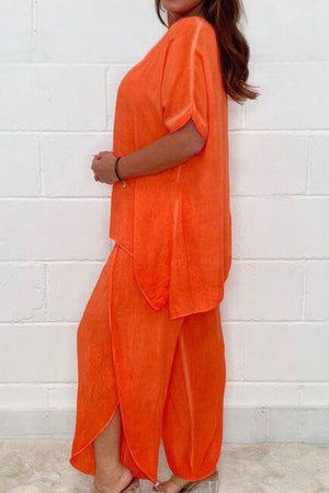 Relaxed linen-like travel 2-piece set in bright orange with loose fit and flowing fabric for effortless style and comfort