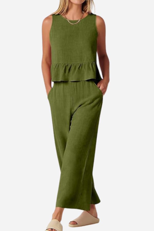 Woman wearing olive green sleeveless linen-like feel set with peplum top and wide-leg pants.