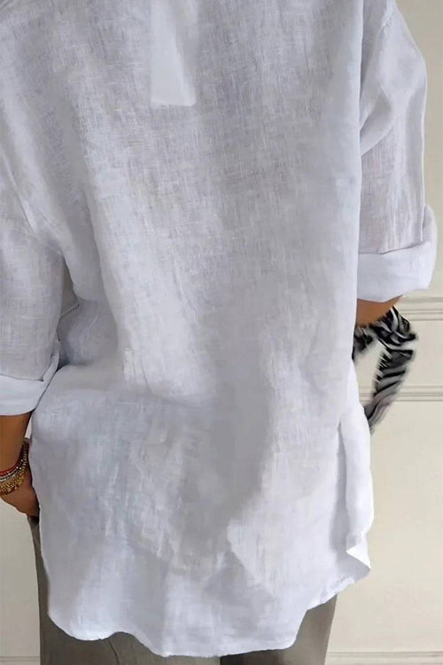 Back view of a white pure linen age-defying shirt with rolled-up sleeves, showing breathable fabric and relaxed fit.