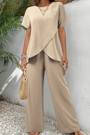 Beige textured elegance two-piece set with asymmetrical top and wide-leg pants for comfortable all-day wear.