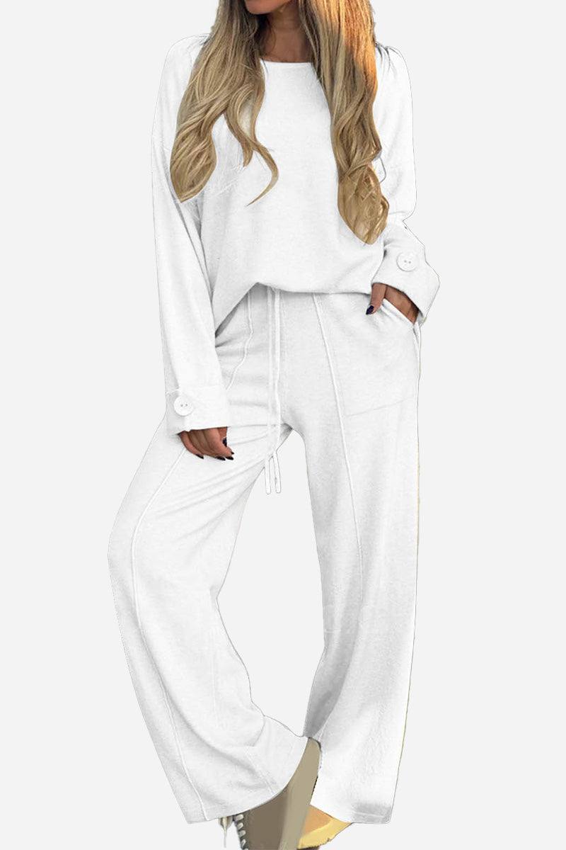 White relaxed fit two-piece set with wide-leg pants and button-cuff top designed for comfortable, wrinkle-resistant travel wear