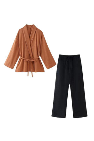 Women's Mix-Match Lounge-to-Travel Set with rust orange belted top and black wide-leg pants, comfortable polyester fabric, travel-friendly and stylish.