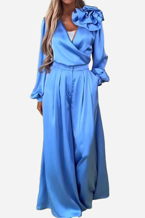 Elegant blue satin two-piece set with statement shoulder blouse and flowing palazzo pants
