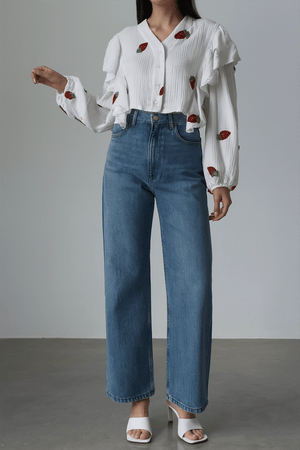 Sweet Countryside 100% cotton ruffled white blouse with strawberry prints paired with blue jeans.