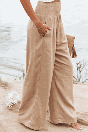 Woman wearing beige linen-cotton blend wide-leg pants from the Linen Breeze Set at the beach.