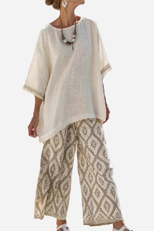 Woman wearing Santorini Sunset Striped two-piece set with loose top and patterned wide-leg pants