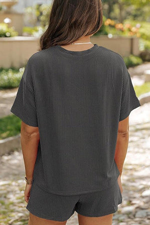 Woman wearing a black striped relaxed-fit top and shorts set for slow mornings outdoors