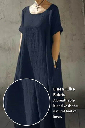 Breeze Cocoon Dress in navy with rolled sleeves, deep side pockets, and linen-like breathable fabric.
