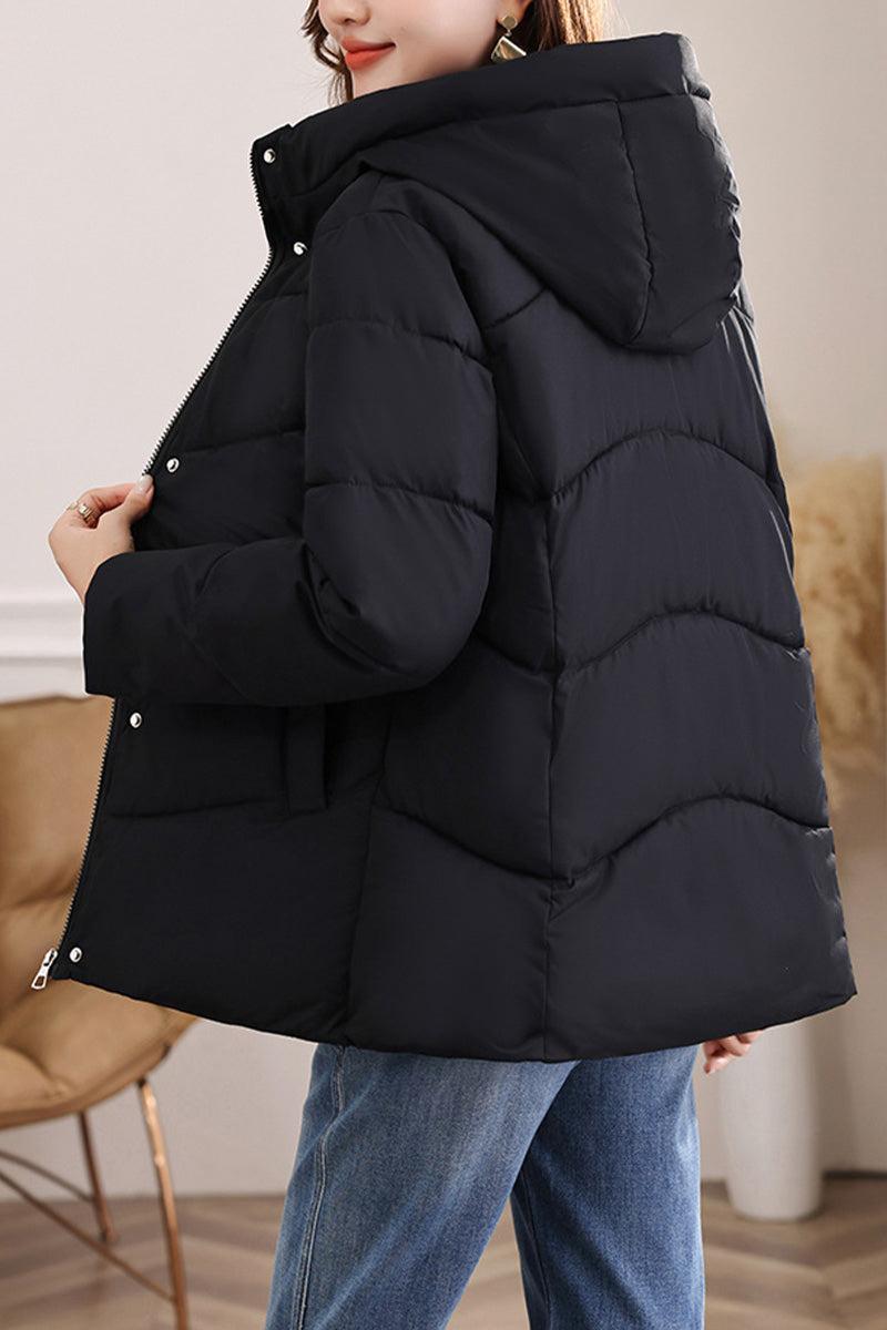 Black mid-length Everyday Warmth Coat with hood, 5-layer thermal insulation, and relaxed fit worn by model with jeans