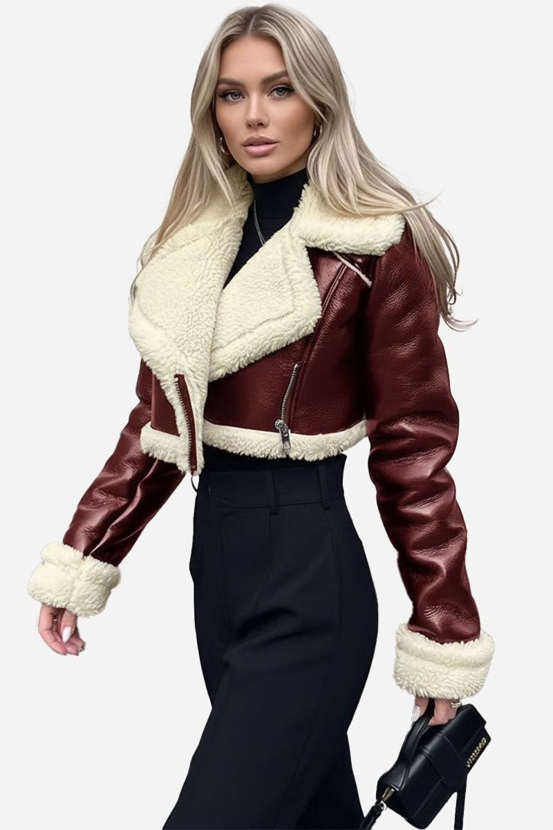 woman wearing cropped faux leather sherpa jacket with cream trim and black pants