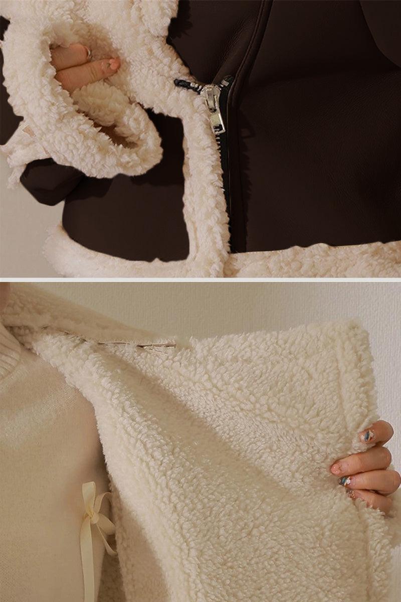 close-up of cropped faux leather sherpa jacket with cream sherpa lining and zipper closure