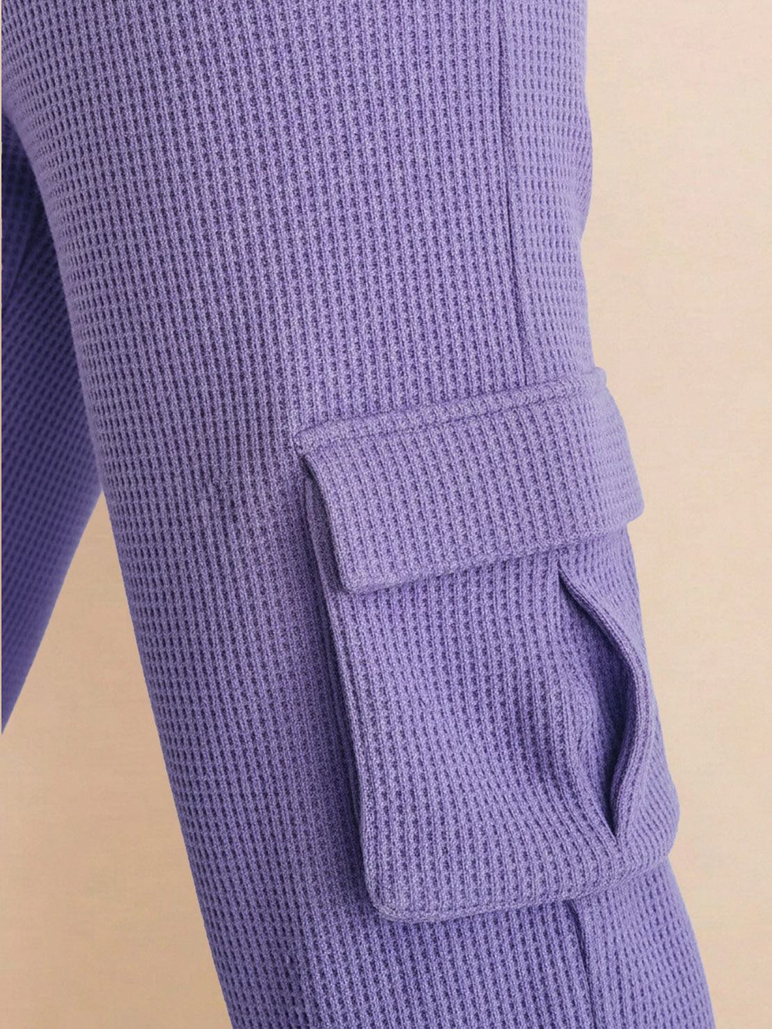 Close-up of purple cotton waffle knit fabric pants with side cargo pocket detail