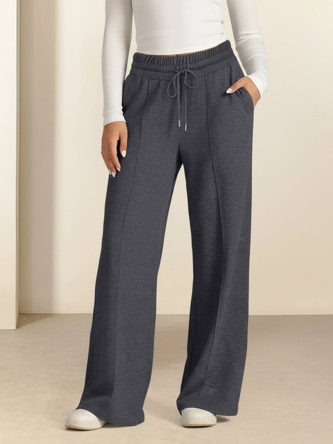 Soft knit wide-leg pants with breathable fabric, elastic drawstring waist, and functional pockets