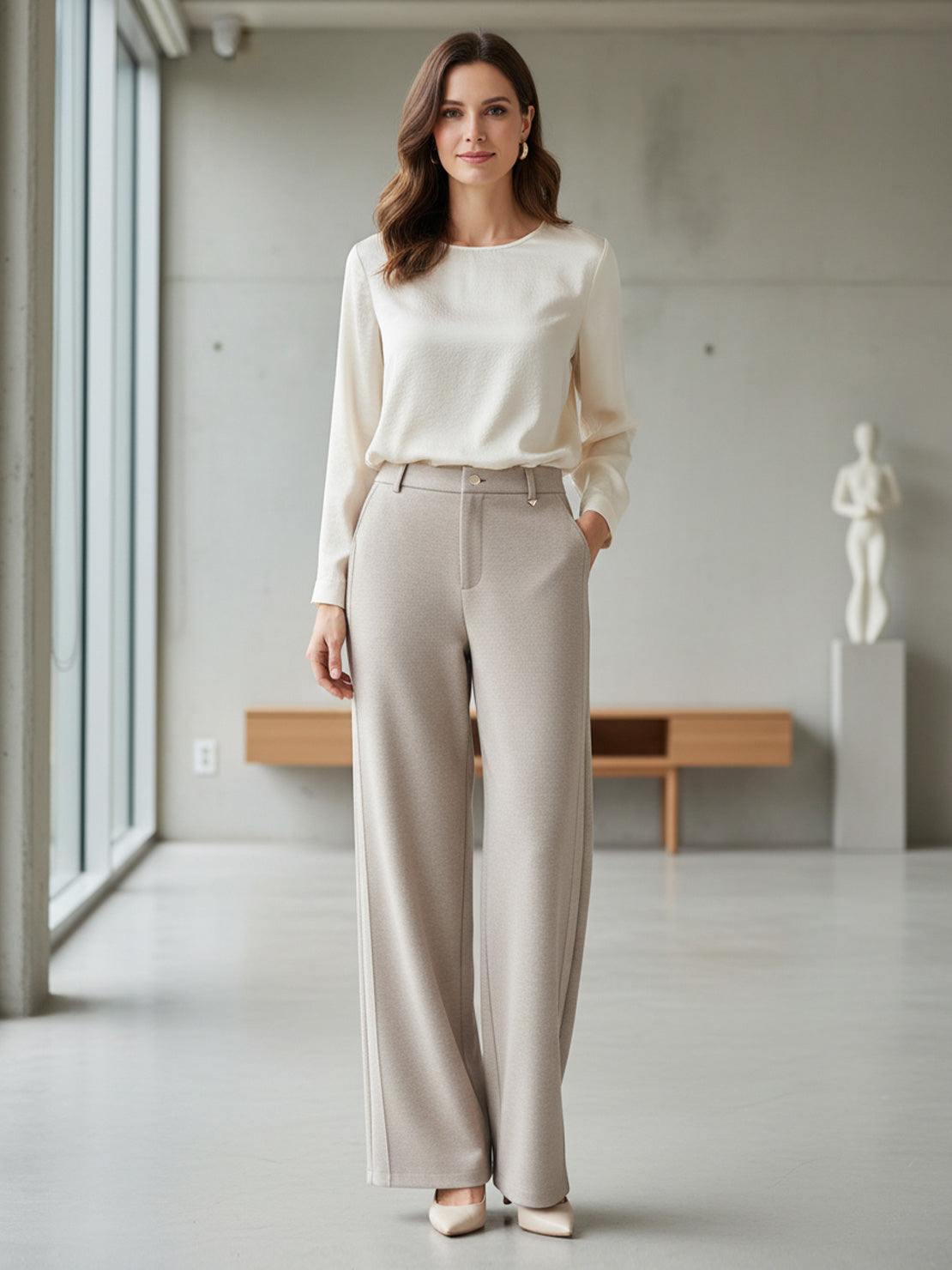 Woman wearing beige wide-leg thermal wool blend trousers with cream long-sleeve top in modern indoor setting
