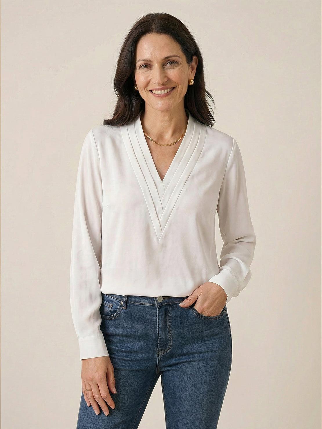 White pleated V-neck long-sleeve blouse with button cuffs and relaxed fit