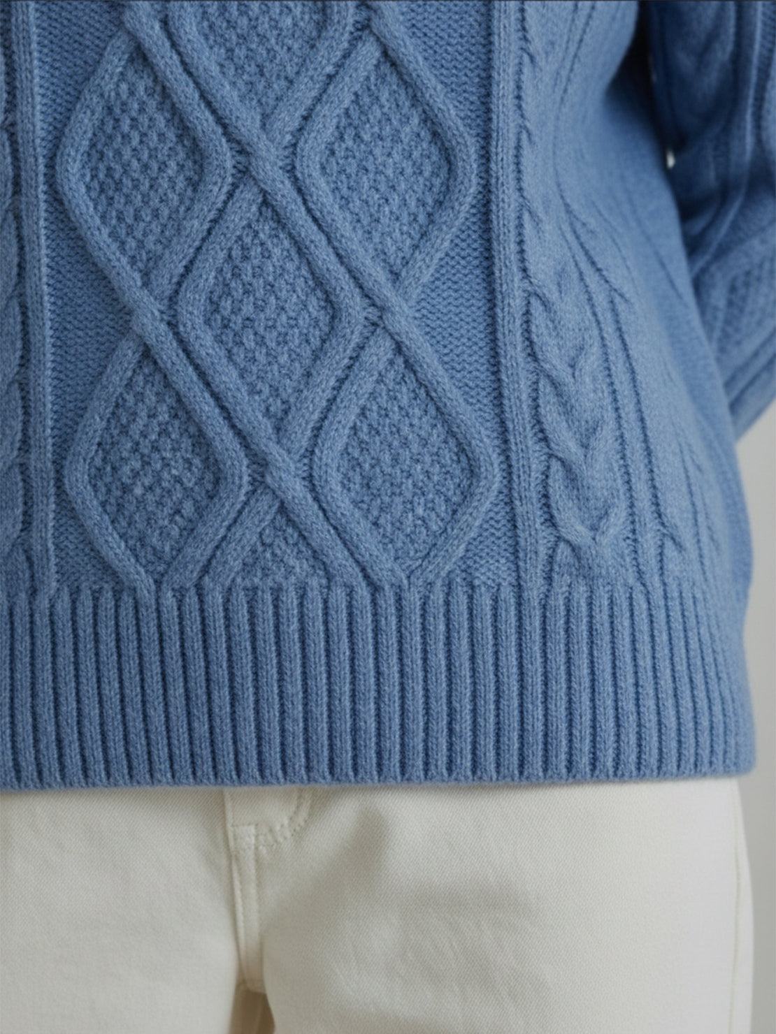 Oversized cable-knit crewneck sweater with dropped shoulders and ribbed trim