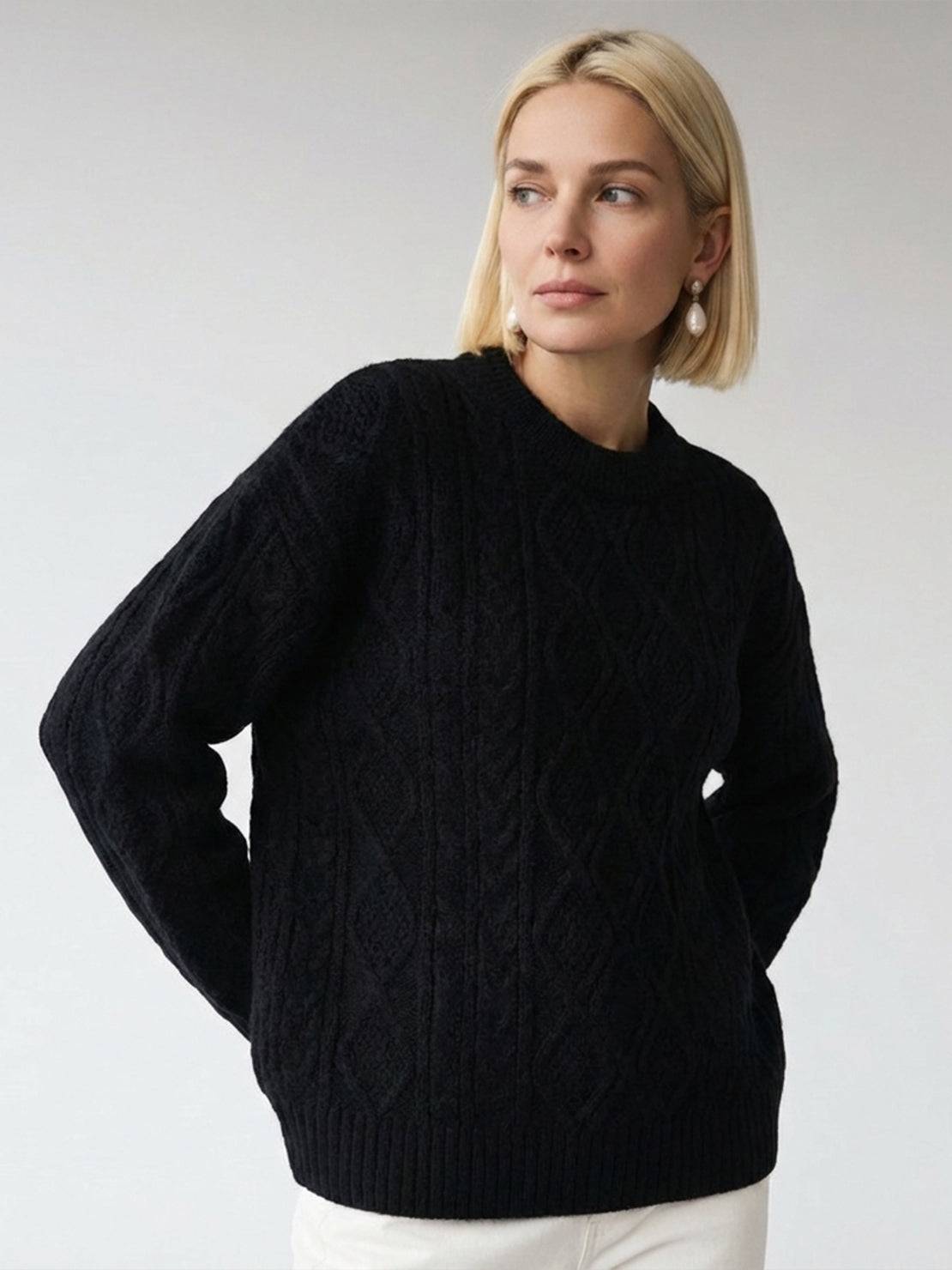 Oversized cable-knit crewneck sweater with dropped shoulders and diamond rope pattern.