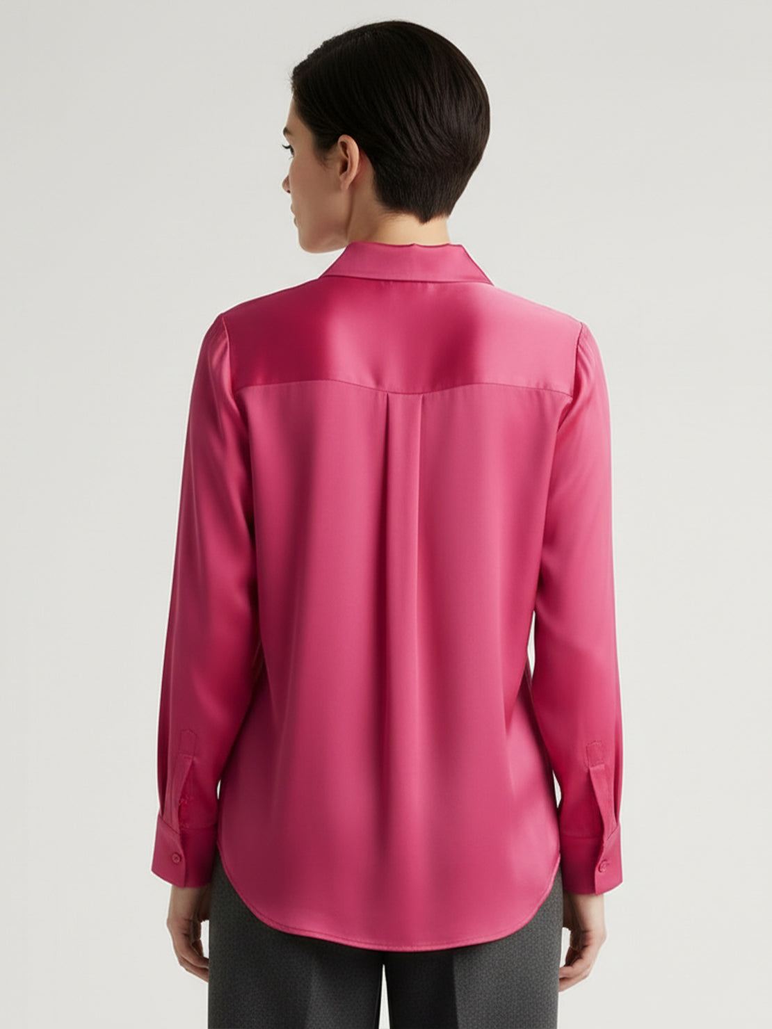 Silk-finish button front shirt with smooth fabric, relaxed fit, and curved hem in polished white